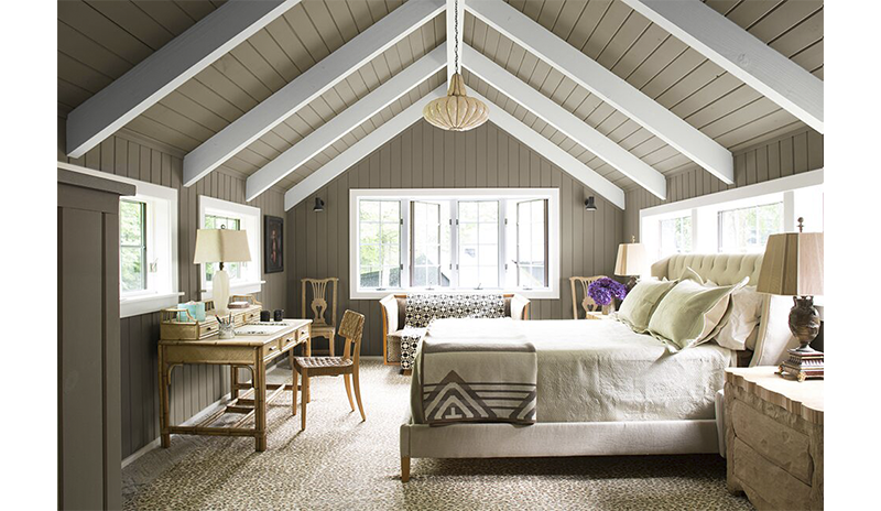 Rich craftsmen bedroom with an angled gray and white ceiling.