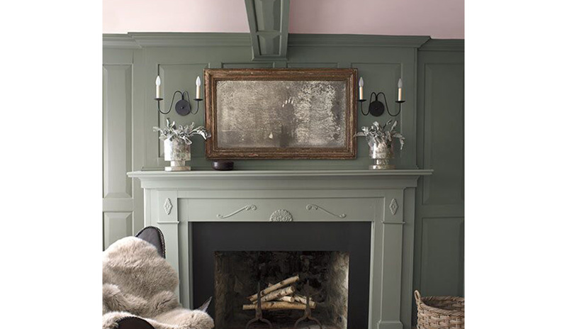 Olive green-painted walls with a light pink-painted ceiling and a muted green fireplace mantle.
