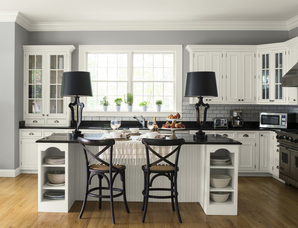 This light gray kitchen keeps it fresh with white cabinetry and subway tile backsplash, adding a das
