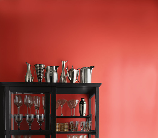Metal pitchers black-painted cabinet with various glasses on the shelves in front of Raspberry Blush