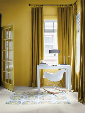 Savannah Green office with contemporary desk and rocking chair, green curtains, and graphic rug.