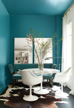 North Sea Green-painted dining room with contemporary dining table and White Heron accent wall. 