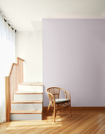 New Age purple-painted accent wall in a room with a wooden chair and White Heron-painted walls.