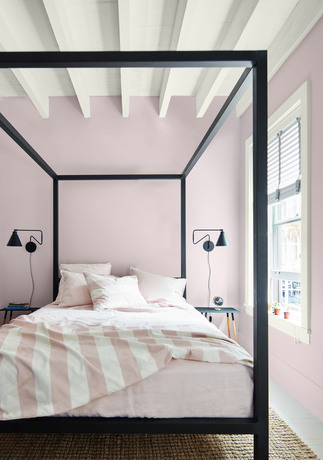 New Age purple-painted bedroom with black bedframe, White Heron-painted ceiling and trim