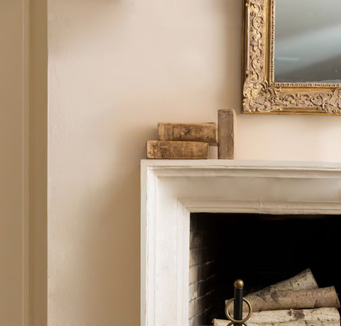 Fireplace mantle with vintage mirror and books