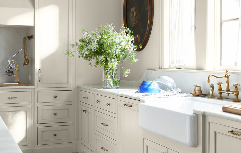 White-painted kitchen in color Gray Mist CC-80 with ample counter space and kitchen island.